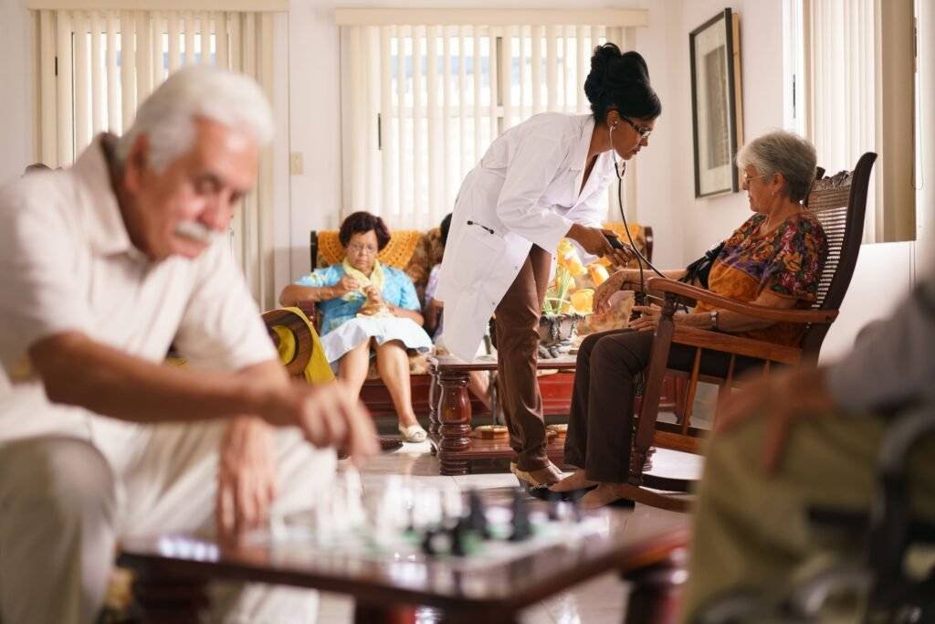 A caregiver checking a senior patient